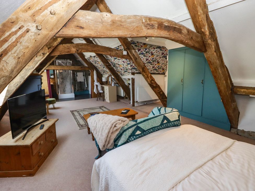 A bedroom with a bed and television at Ty Mawr Country House, Carmarthen