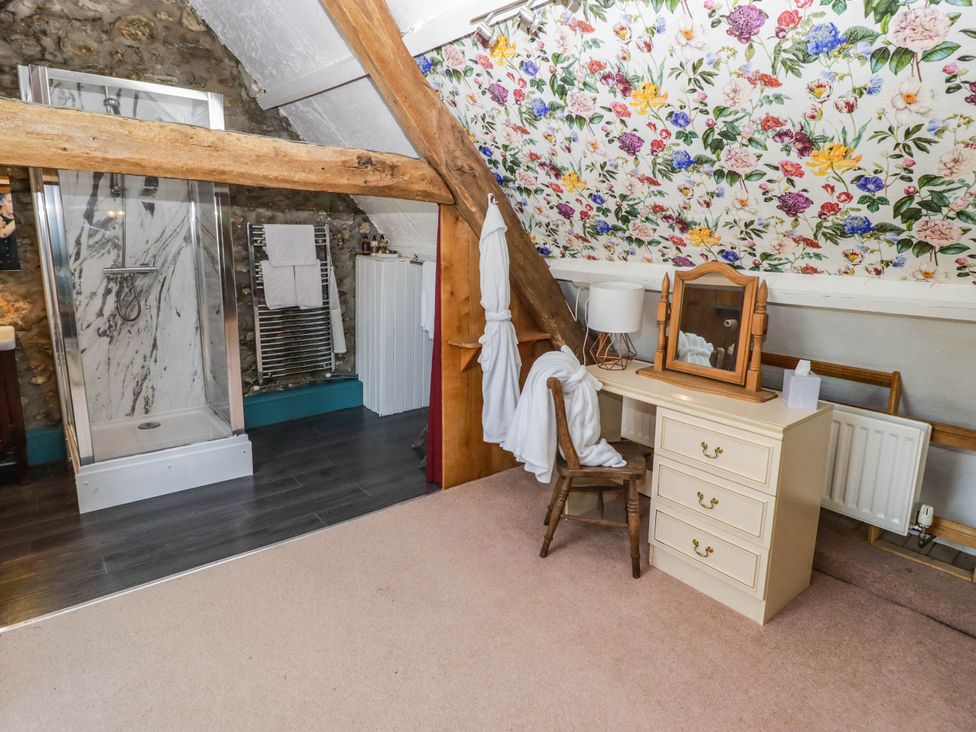 A bathroom with a shower and vanity at Ty Mawr Country House in Carmarthen