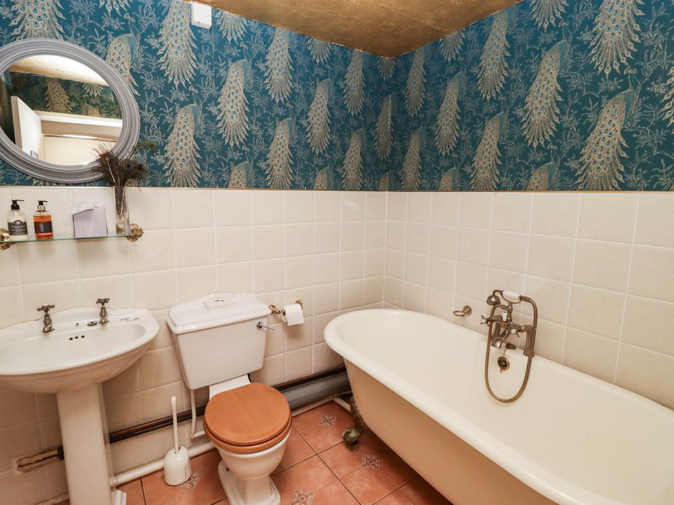 A bathroom featuring a sink, toilet, and bathtub at Ty Mawr Country House in Carmarthen