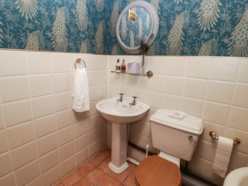 A bathroom with a sink and toilet at Ty Mawr Country House in Carmarthen