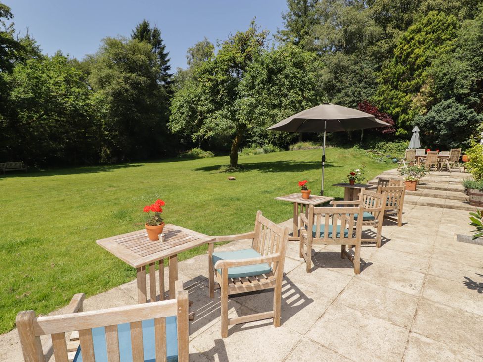 A garden setting with tables and chairs at Ty Mawr Country House in Carmarthen