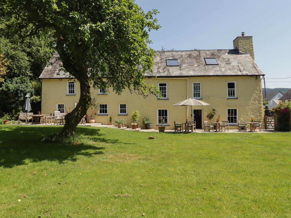 A house with a garden and patio at Ty Mawr Country House in Carmarthen