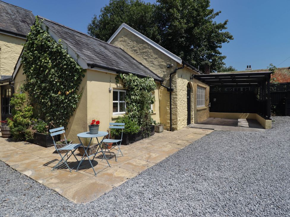 An outdoor space with a table and chairs at Ty Mawr Country House in Carmarthen