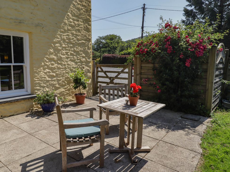 A garden with a table and chairs at Ty Mawr Country House in Carmarthen