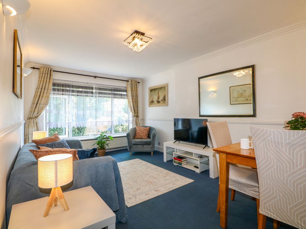 A living room with a sofa and television at 4 Sussex Close in Watford