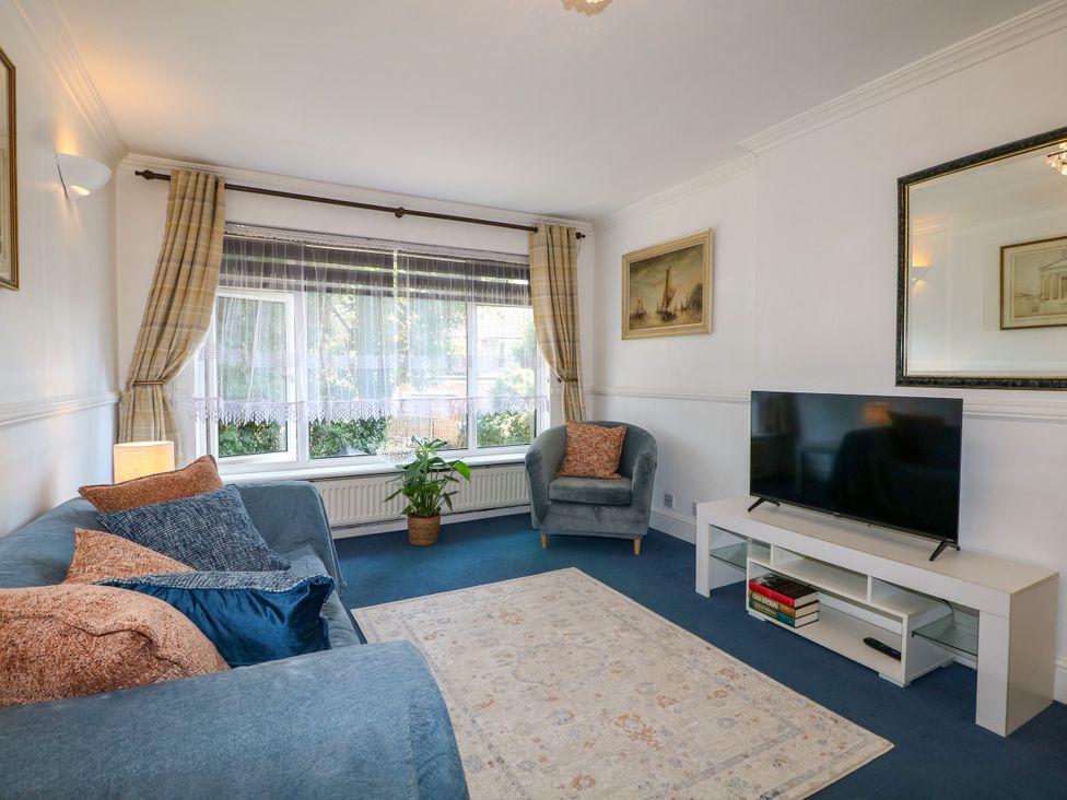 A living room with a sofa and TV at 4 Sussex Close Watford