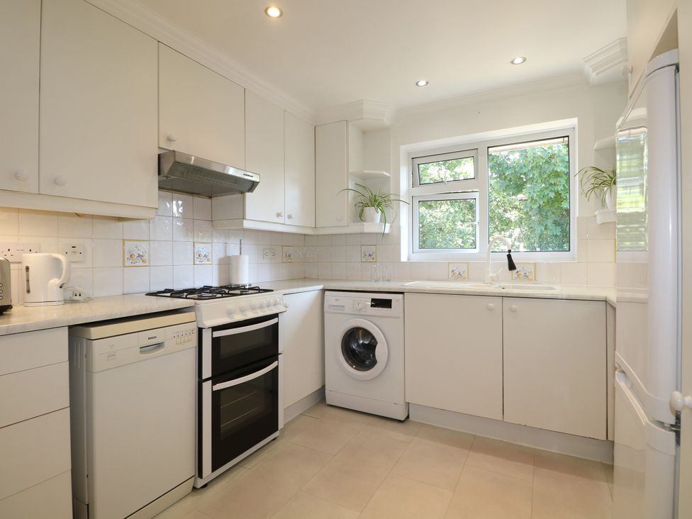 A kitchen with appliances including a dishwasher and washing machine at 4 Sussex Close in Watford