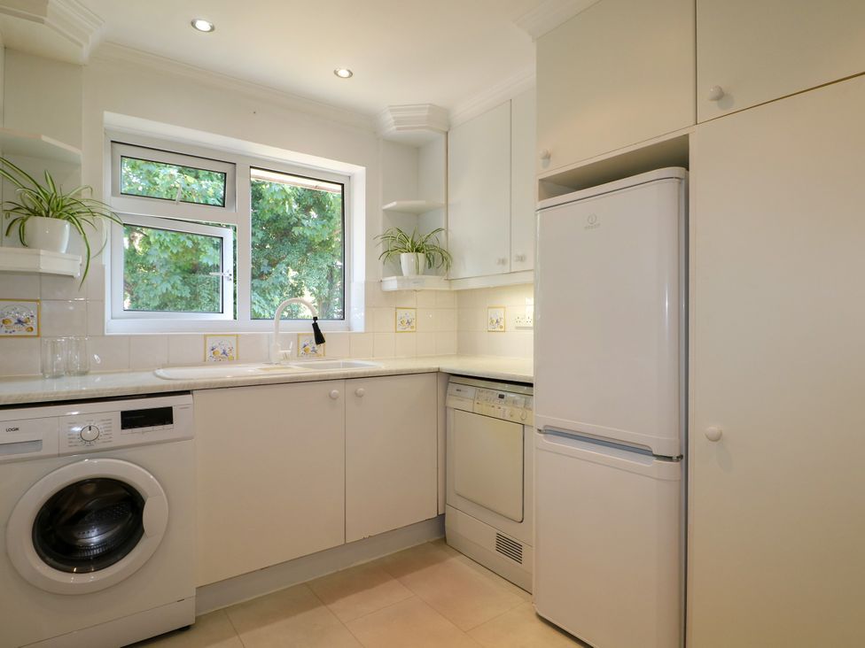 A kitchen with appliances and a window at 4 Sussex Close Watford