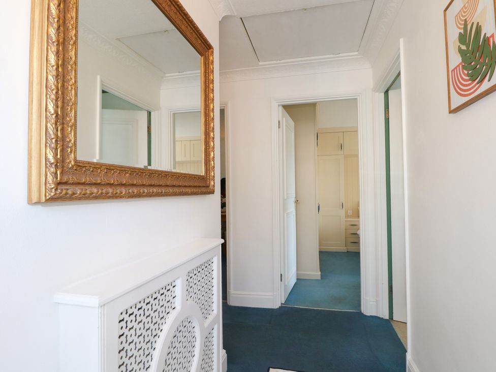 A hallway with a mirror and closet at 4 Sussex Close, Watford