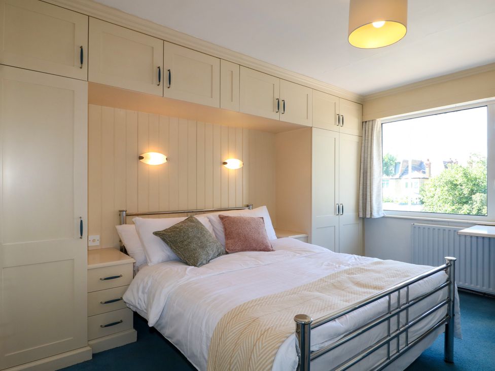 A bedroom with a bed and window at 4 Sussex Close in Watford