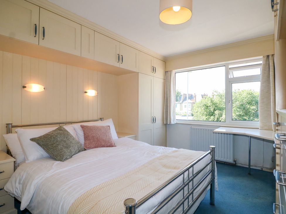 A bedroom with a bed and a desk at 4 Sussex Close Watford
