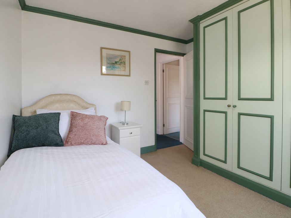 A bedroom with a bed and wardrobe at Sussex Close in New Malden