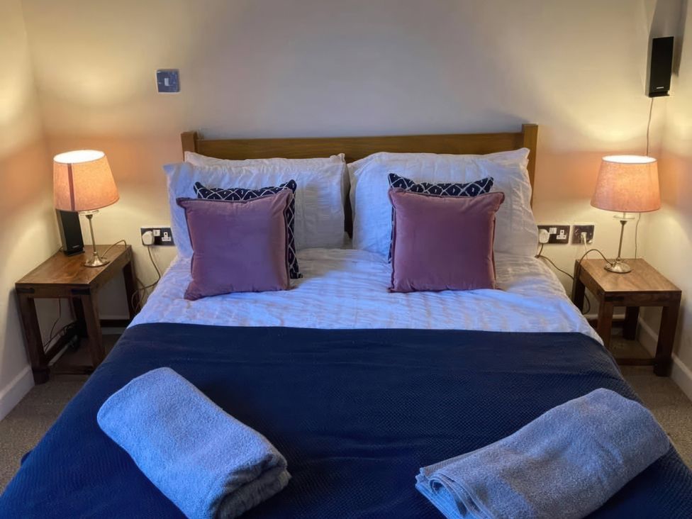 A bedroom with a bed and bedside lamps at Admirals Rest in Weymouth