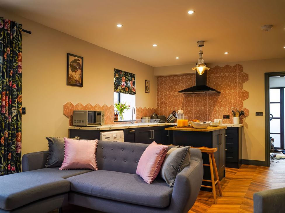 A kitchen with a sofa and modern appliances at The Old Mill in Great Bolas near Telford