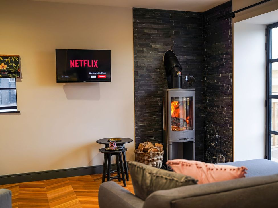 A living room with a television and fireplace at The Old Mill Great Bolas near Telford