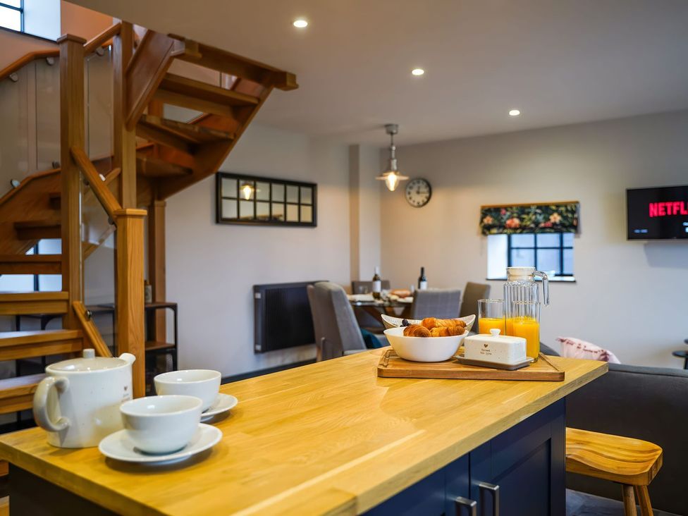 A kitchen with staircase and dining area at The Old Mill near Telford