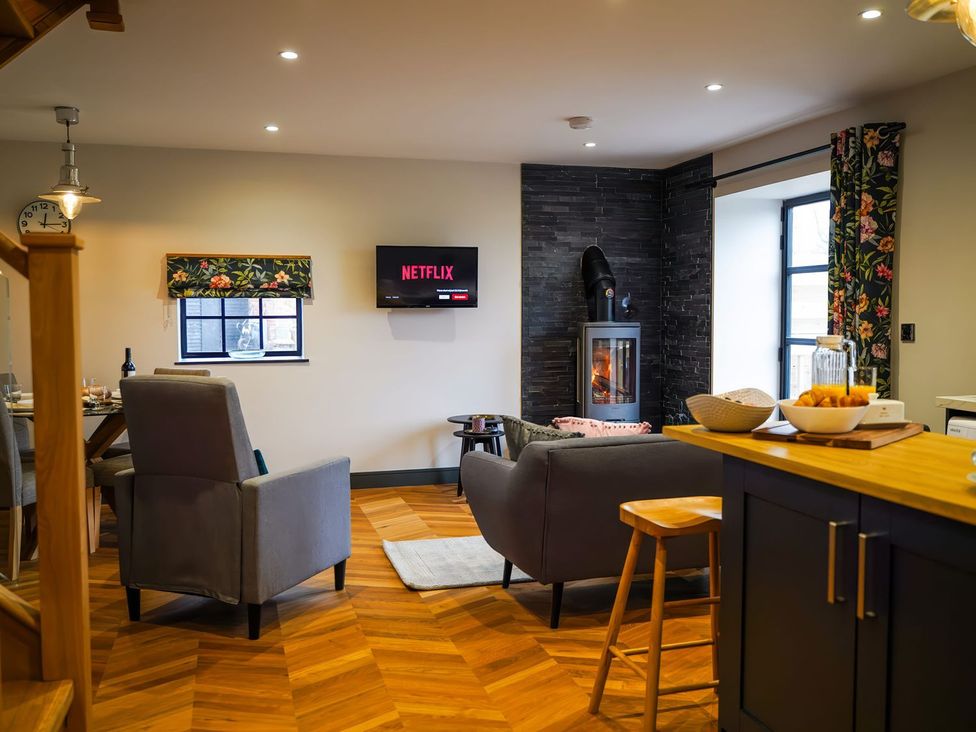 A living room with a sofa and television at The Old Mill in Great Bolas near Telford