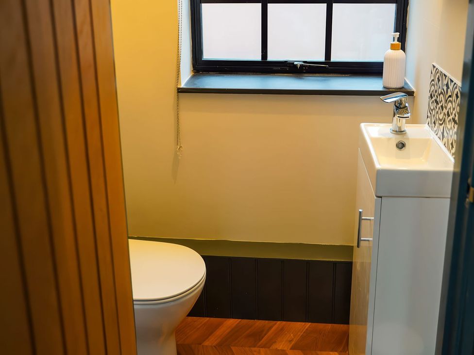 A bathroom with a toilet and sink at The Old Mill in Great Bolas near Telford