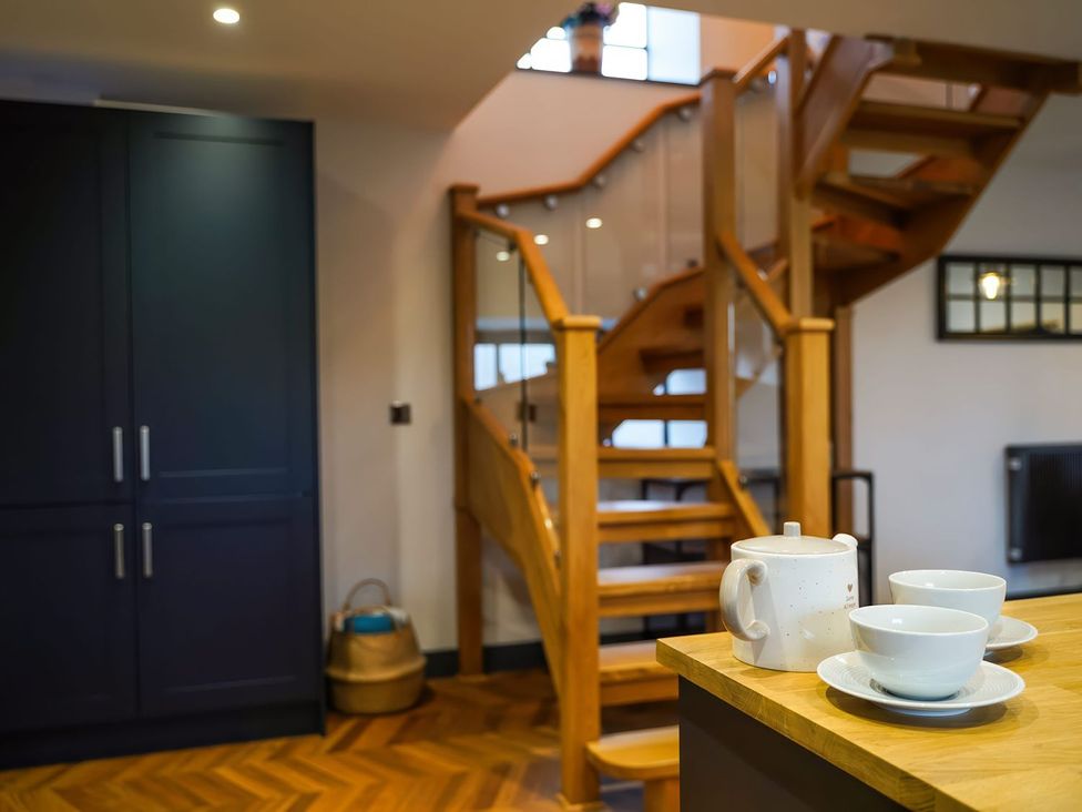 A kitchen with a staircase and dinnerware at The Old Mill Great Bolas near Telford