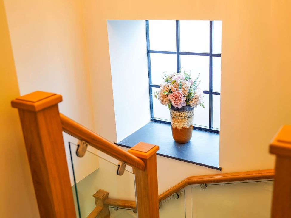 A staircase with a window and flower pot at The Old Mill Great Bolas near Telford