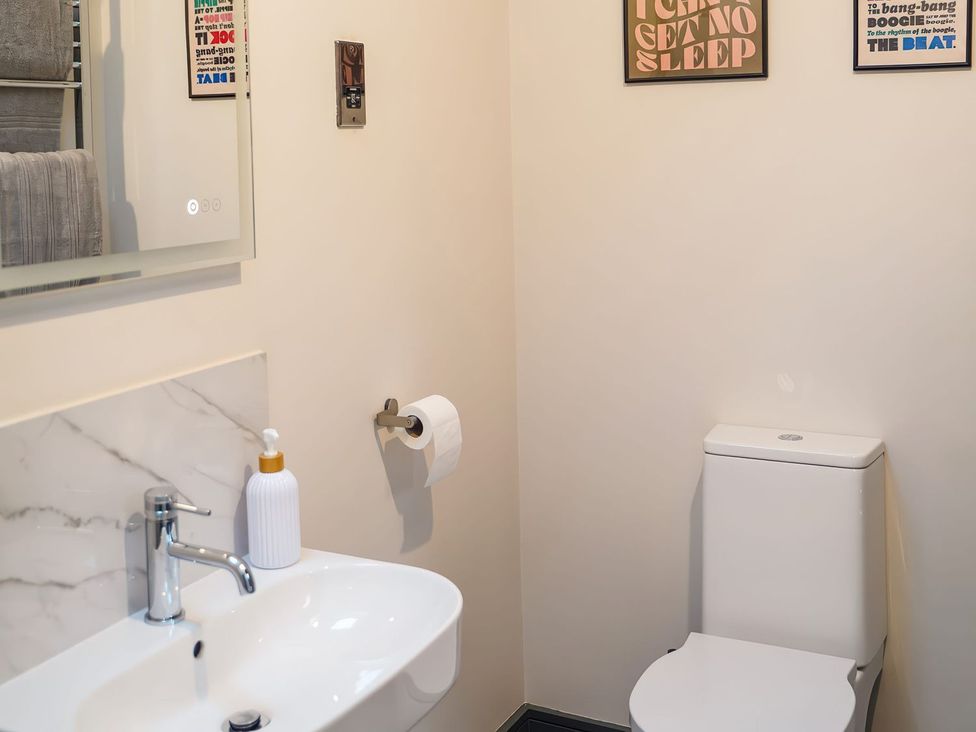 A bathroom with a sink and toilet at The Old Mill in Great Bolas near Telford