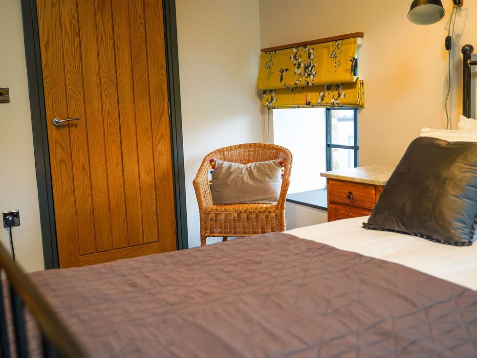 A bedroom with a bed and a chair at The Old Mill Great Bolas near Telford