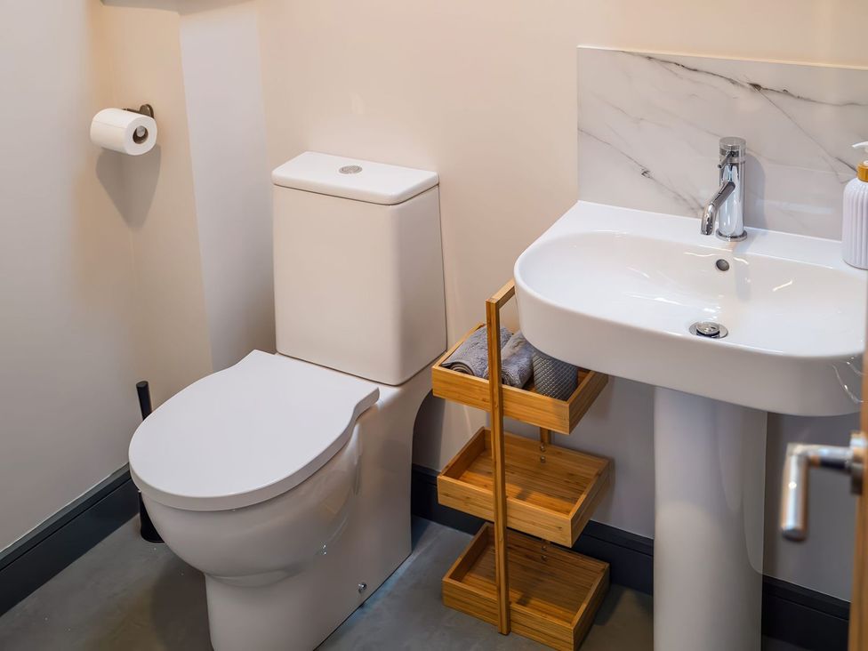 A bathroom with a toilet and a sink at The Old Mill in Great Bolas near Telford