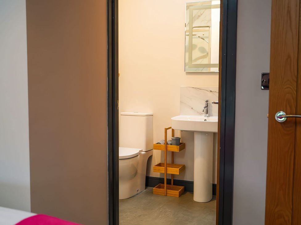 A bathroom with a toilet and sink at The Old Mill Great Bolas near Telford