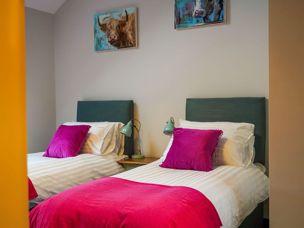 A bedroom with two beds and wall art at The Old Mill in Great Bolas near Telford