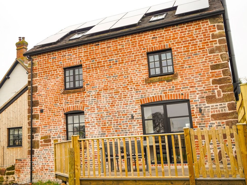 An outdoor view of a house with solar panels at The Old Mill in Great Bolas near Telford