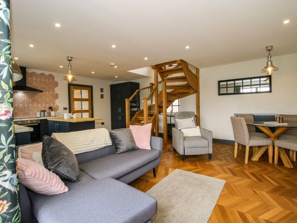 A living room with a sofa and dining area at The Old Mill Great Bolas near Telford