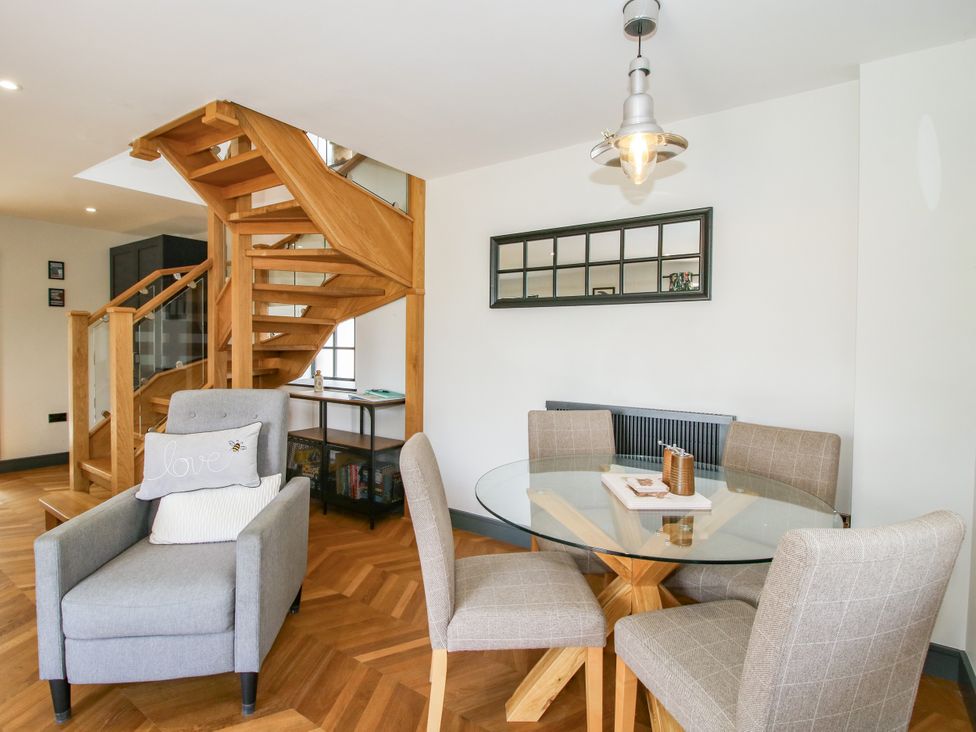 A living room with a staircase and dining area at The Old Mill Great Bolas near Telford