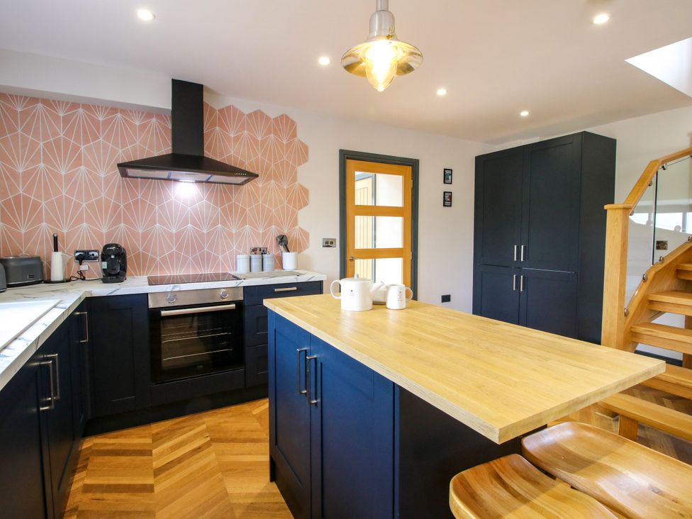 A kitchen with a stove and kitchen island at The Old Mill Great Bolas near Telford