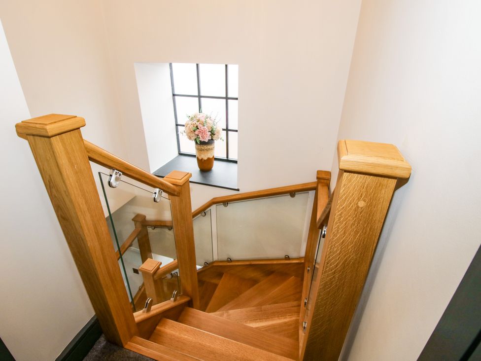 A staircase with a window and flower pot at The Old Mill in Great Bolas near Telford