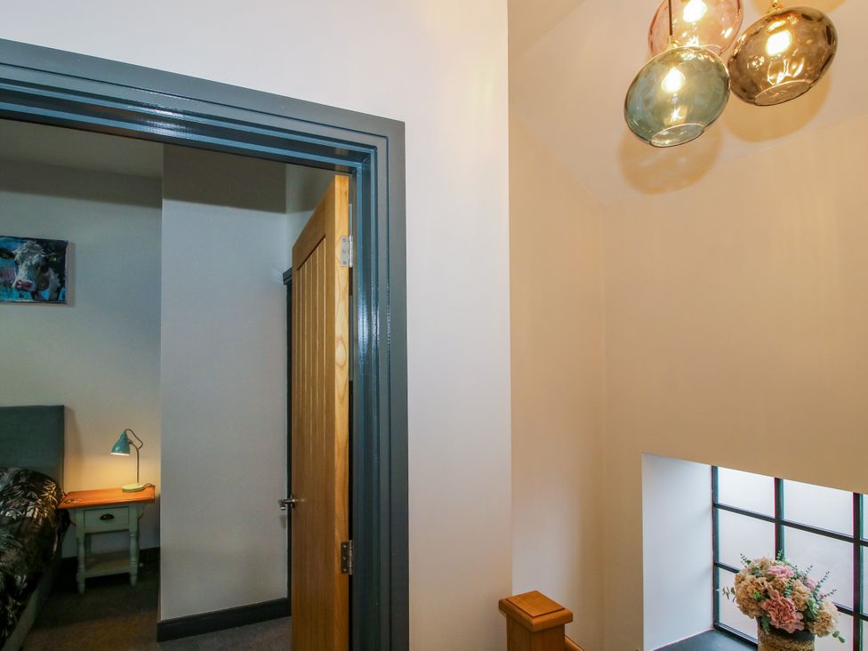A bedroom with a door and furniture at The Old Mill in Great Bolas near Telford