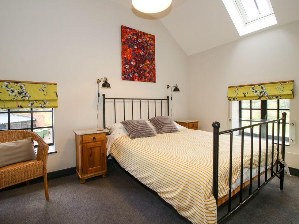A bedroom with a bed and a chair at The Old Mill Great Bolas near Telford