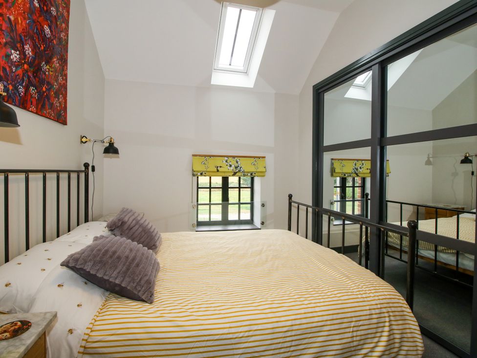 A bedroom with a bed and window at The Old Mill in Great Bolas near Telford