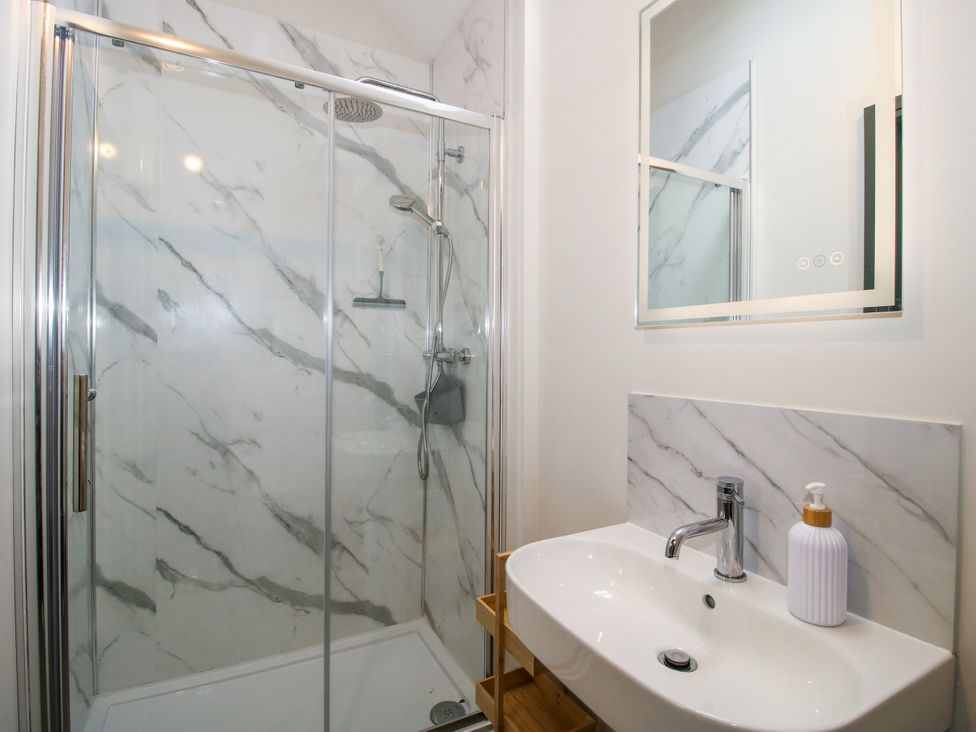 A bathroom with a shower and sink at The Old Mill in Great Bolas near Telford