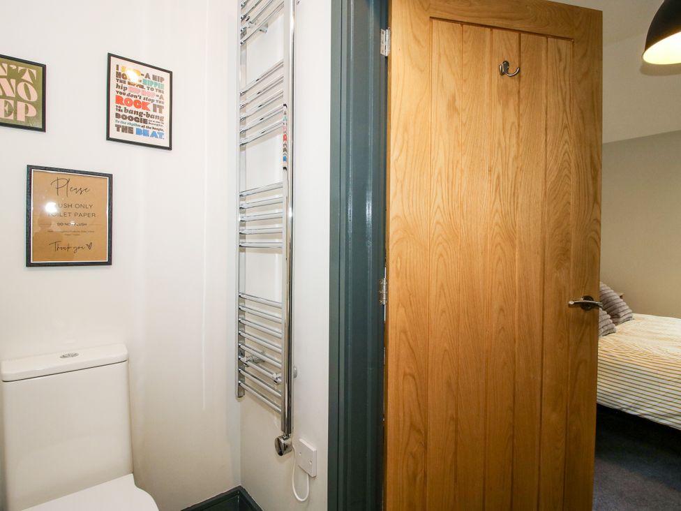 A bathroom with a toilet and towel rail at The Old Mill in Great Bolas near Telford