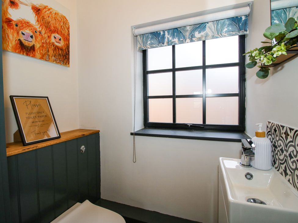 A bathroom with a toilet and hand basin at The Old Mill in Great Bolas near Telford