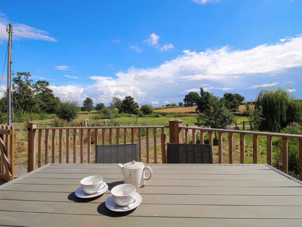 A table with a tea set and cups on an outdoor deck at The Old Mill in Great Bolas near Telford