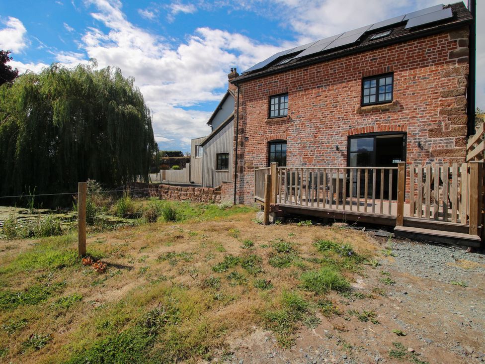 An outdoor view of a brick house with a deck in The Old Mill Great Bolas near Telford