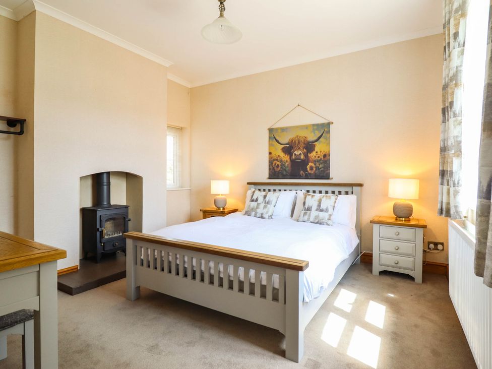 A bedroom with a bed and furniture at Pwll Glas, Caersws