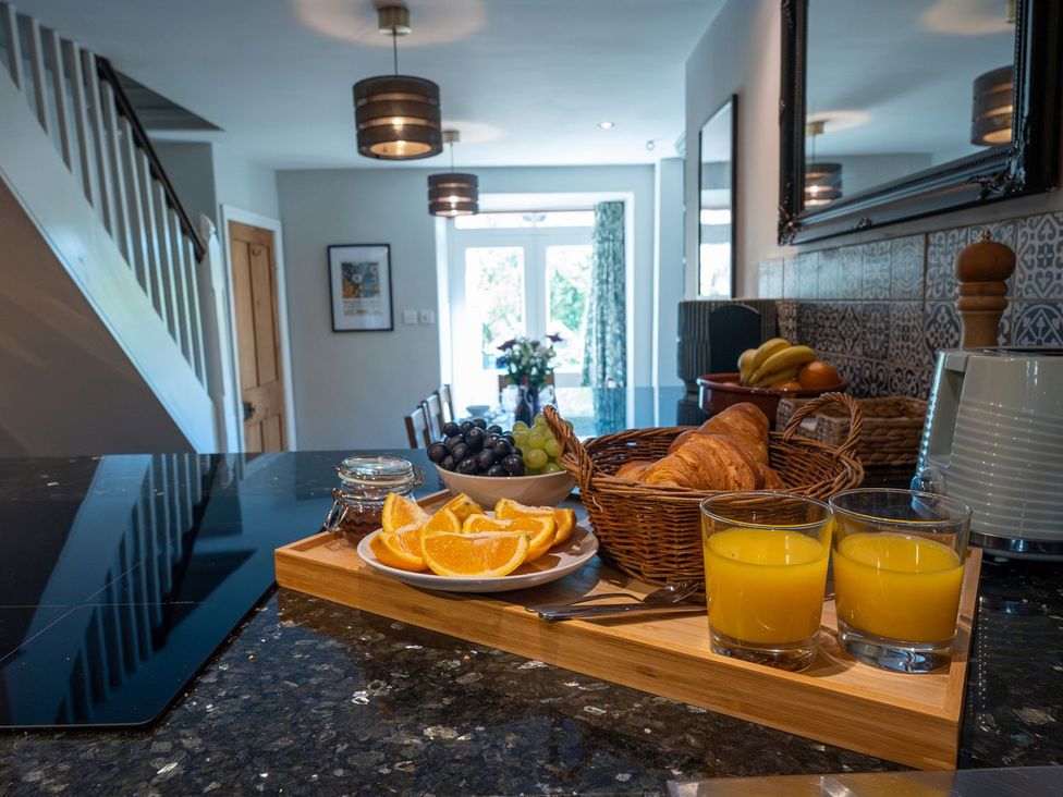 A kitchen with fruit and drinks on the counter at Gwynfryn House in Llanbedr