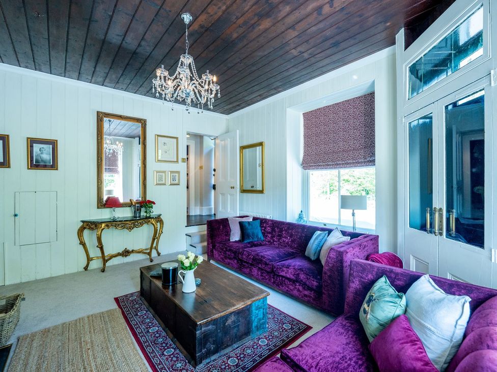 A living room with a coffee table and two sofas at Gwynfryn House in Llanbedr