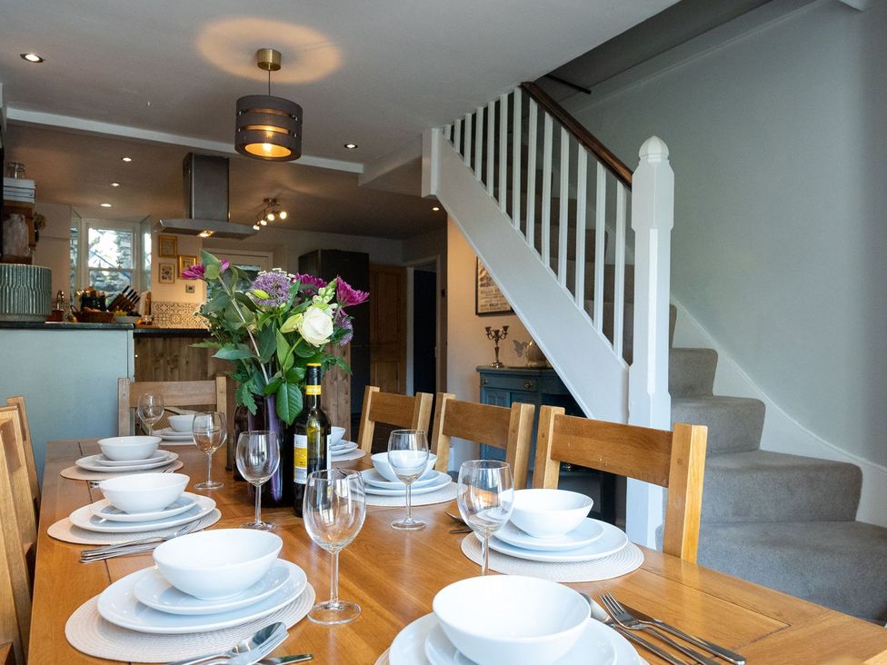 A dining room with a table set for a meal at Gwynfryn House in Llanbedr