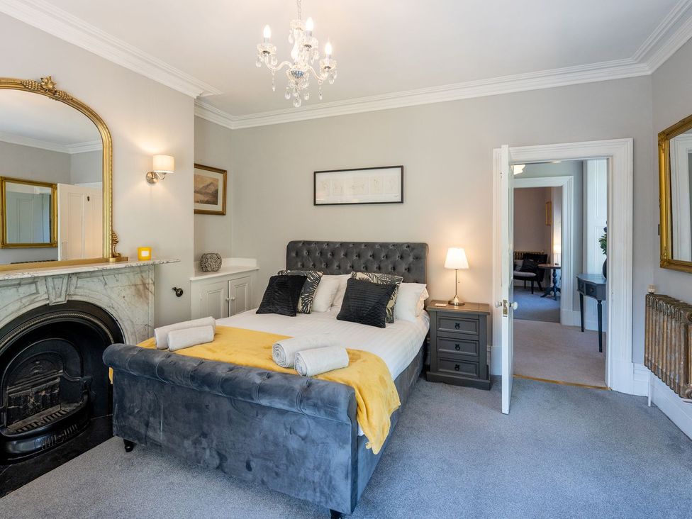 A bedroom with a bed and nightstand at Gwynfryn House in Llanbedr