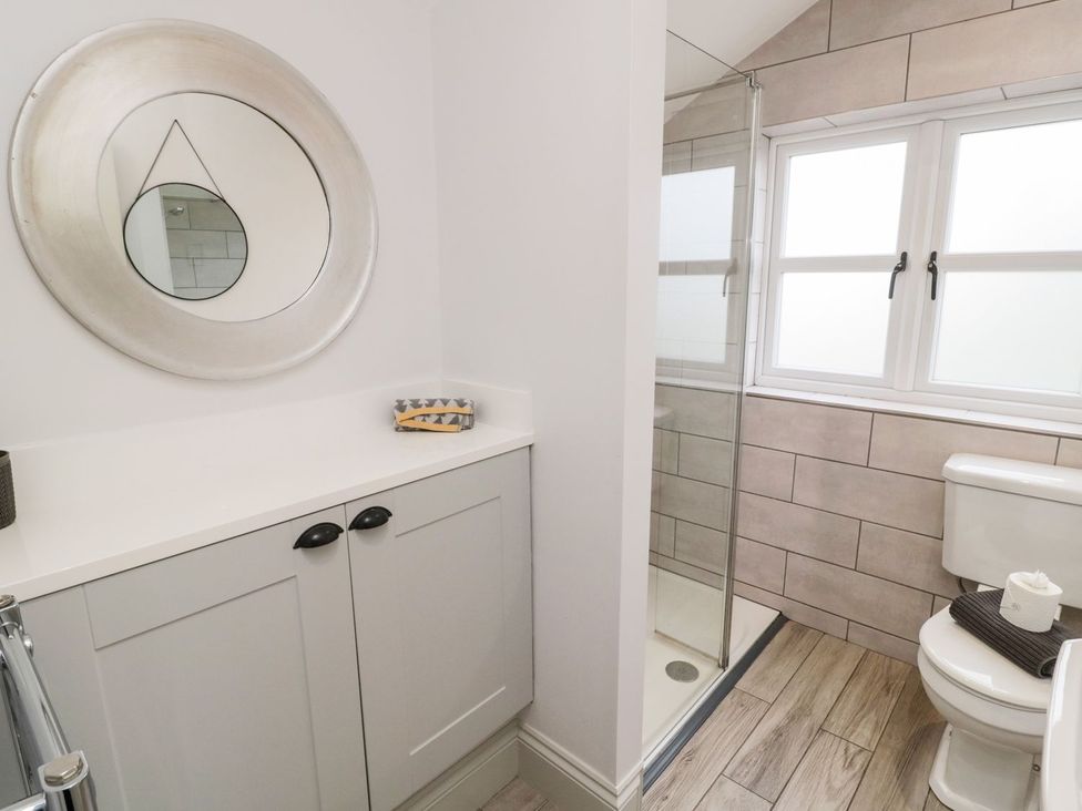 A bathroom with a shower and toilet at Canny Cottage in Belford