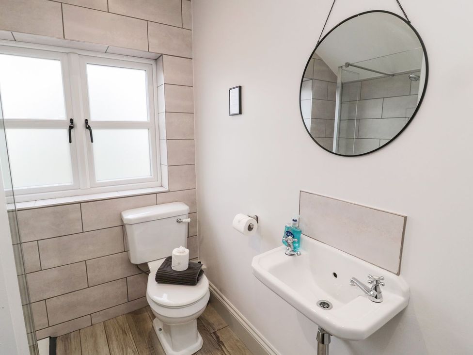 A bathroom with a toilet and wash basin at Canny Cottage in Belford