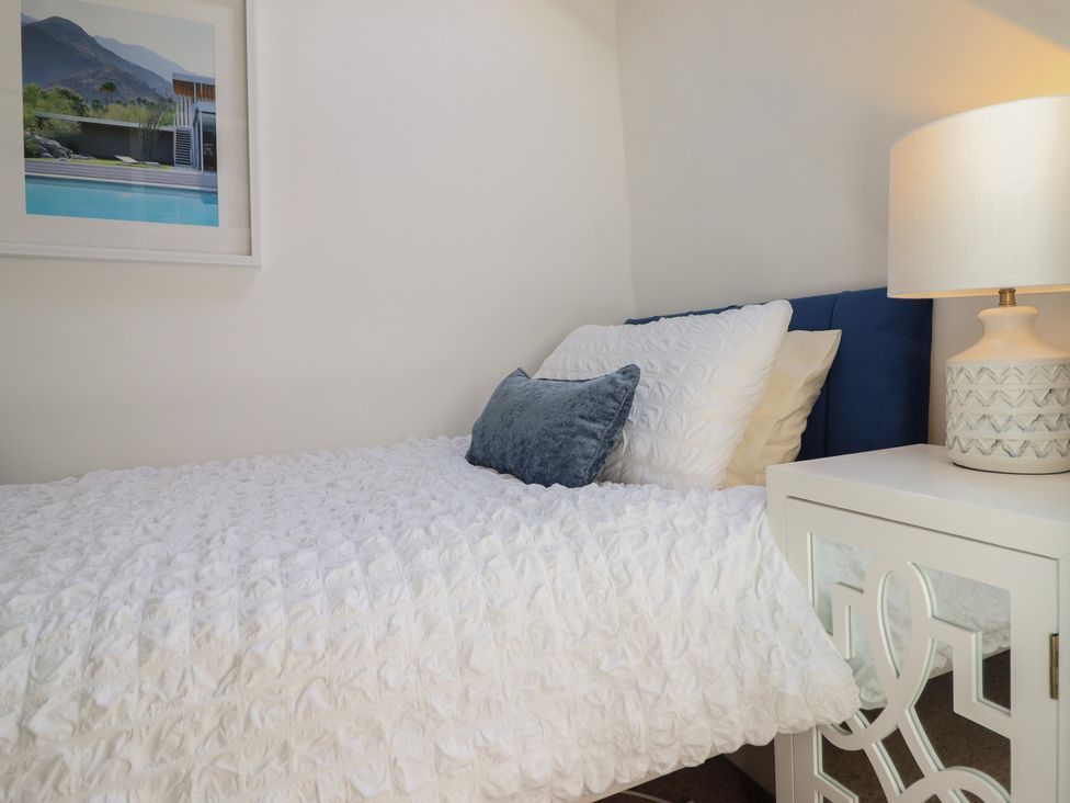 A bedroom with a bed and a nightstand at Cnicht View in Porthmadog